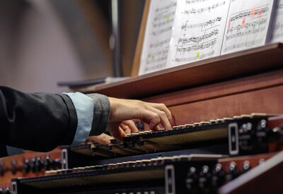 organist playing a pipe organ